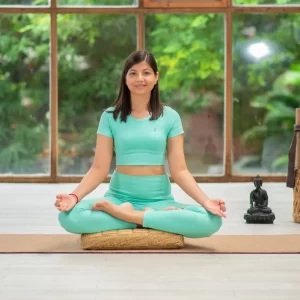 a-black-haired-yoga-practioner-wearing-blue-outfit-using-juru-yavasa-meditation-cushion